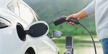 Electric,Car,Or,Ev,Is,Charging,At,Station,.,Man