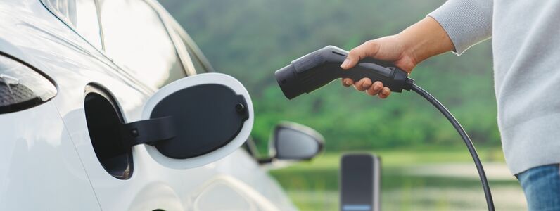 Electric,Car,Or,Ev,Is,Charging,At,Station,.,Man